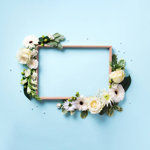 Frame of white flowers over blue background. Valentines day, Woman day concept. Spring or summer banner with copy space - Fotó, kép
