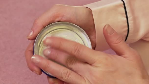 Woman with almost empty moisturizer cream container - Imágenes, Vídeo