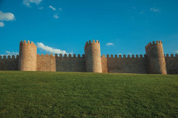 Large wall with towers over hilly landscape encircling Avila - Valokuva, kuva