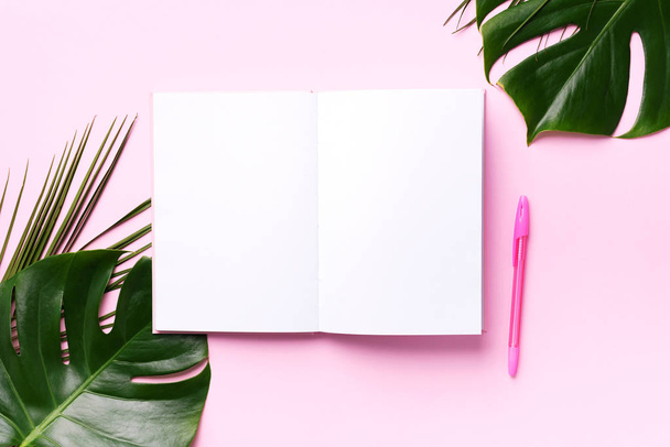 Green monstera, palm leaves, coconut, notebooks over pink background. Female blog writer workspace, back to school concept. Flat lay. Top view. - Fotoğraf, Görsel