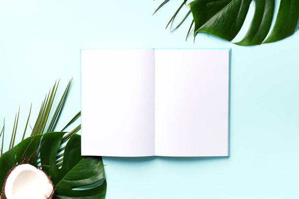 Green monstera, palm leaves, coconut, notebooks over pink background. Female blog writer workspace, back to school concept. Flat lay. Top view. - Foto, immagini