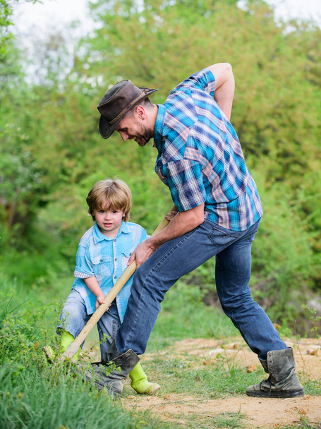 Find treasures. Little boy and father with shovel looking for treasures. Happy childhood. Adventure hunting for treasures. Little helper working in garden. Cute child in nature having fun with shovel - Fotó, kép