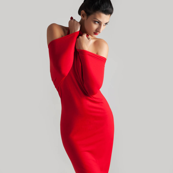 Portrait of beautiful brunette woman with red elastic cloth.  - Fotó, kép