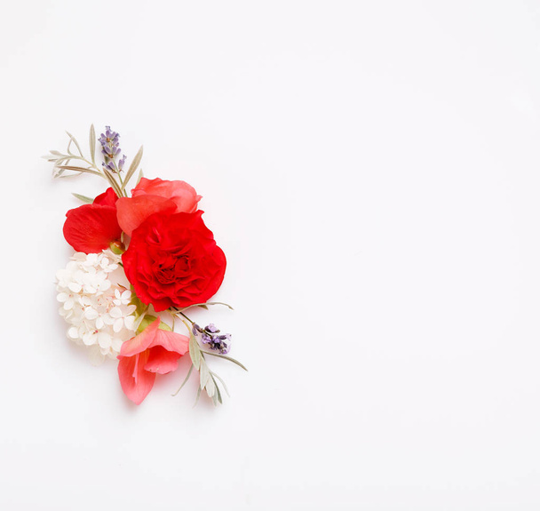 Festive flower composition on the white wooden background. Overhead view - Zdjęcie, obraz