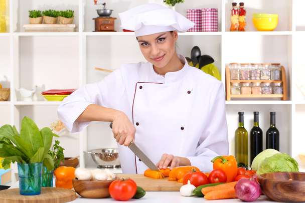 Young woman chef cooking in kitchen - Photo, Image