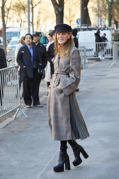 Anna dello Russo with gray coat and black hat before Fendi fashion show, Milan Fashion Week street style  - Photo, Image
