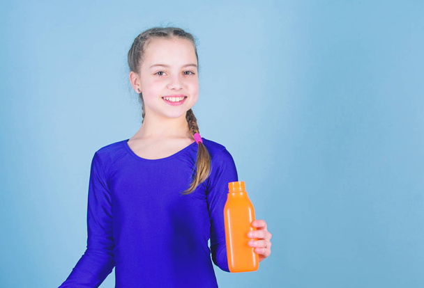 Quench thirst. Child feel thirst after sport training. Kid cute girl gymnast sports leotard hold bottle for drink. Water balance and hard gym training. Drink more water. Keep water bottle with you - Photo, image