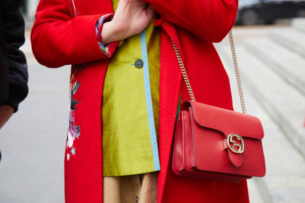 Woman with red coat and Gucci leather bag with golden chain before Frankie Morello fashion show, Milan Fashion Week street style  - Valokuva, kuva