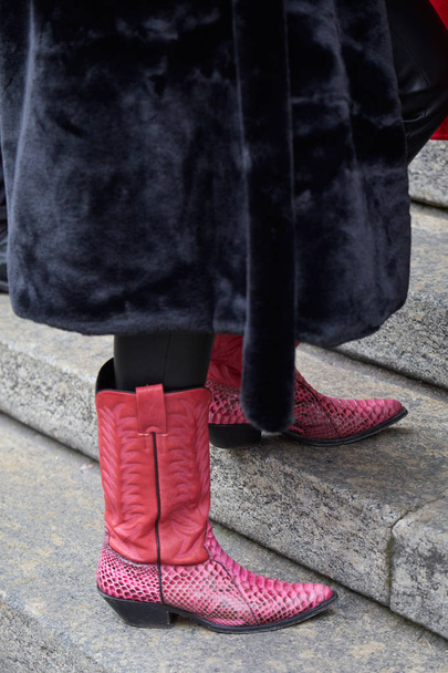 Woman with pink leather cowboy boots and black fur coat before Frankie Morello fashion show, Milan Fashion Week street style  - Foto, Imagen