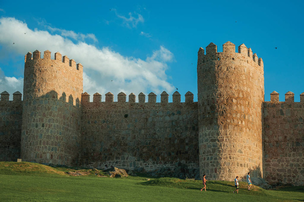 Stone large wall with towers and people encircling Avila - Foto, Bild