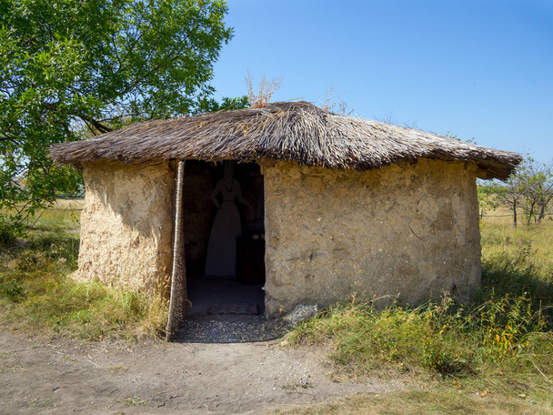 Mud hut with a reed roof, archaeological park "From nomadic to cities", Divnogorye, Voronezh region - Photo, Image