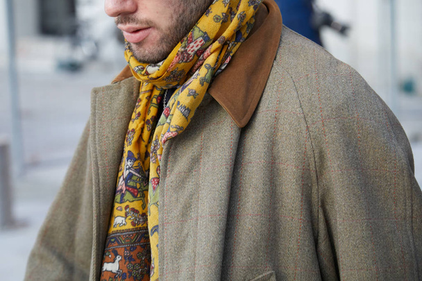 Man with yellow scarf and beige coat before Neil Barrett fashion show, Milan Fashion Week street style  - Foto, immagini