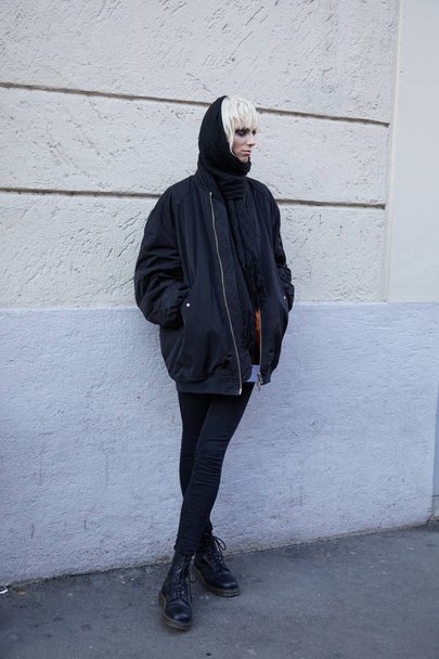 Woman with black bomber jacket and blond hair before Spyder fashion show, Milan Fashion Week street style  - Zdjęcie, obraz