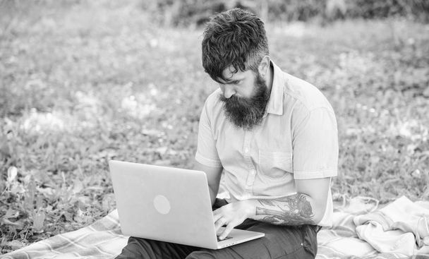 Man bearded with laptop sit meadow nature background. Blogger becoming inspired by nature. Writer looking for inspiration nature environment. Inspiration for blogging. Looking for inspiration - Fotó, kép