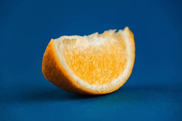 juicy orange sliced on a blue background, Popular healthy fruit. - Фото, зображення