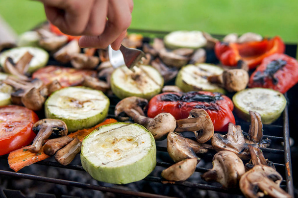 Grill party in a garden.  Healthy food preparing outdoors on summer or spring picnic - Photo, Image