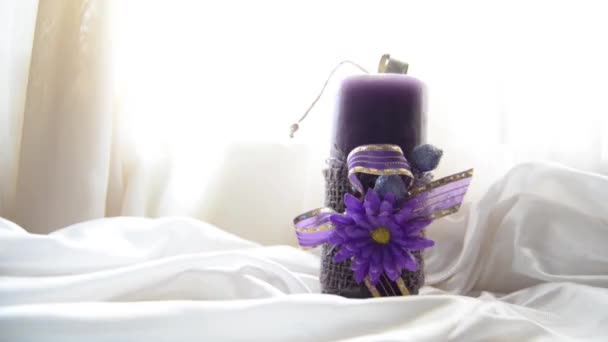 purple candle on the silk bedding - sensual shot - Footage, Video