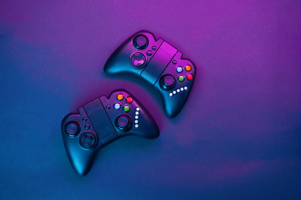 Gamepads on violet table background. - Photo, Image