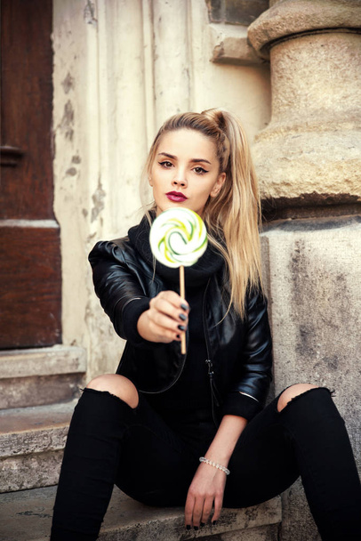 Young beautiful woman with lollipop in city - Foto, Imagem