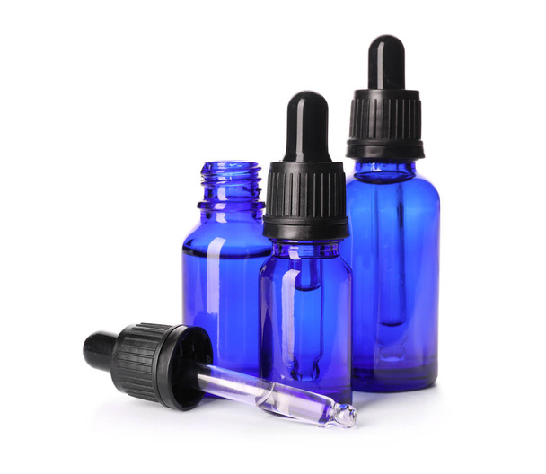 Cosmetic bottles of essential oils on white background - Foto, Imagem