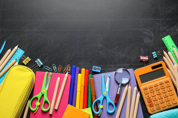 Flat lay composition with scissors and school supplies on dark background. Space for text - Photo, Image