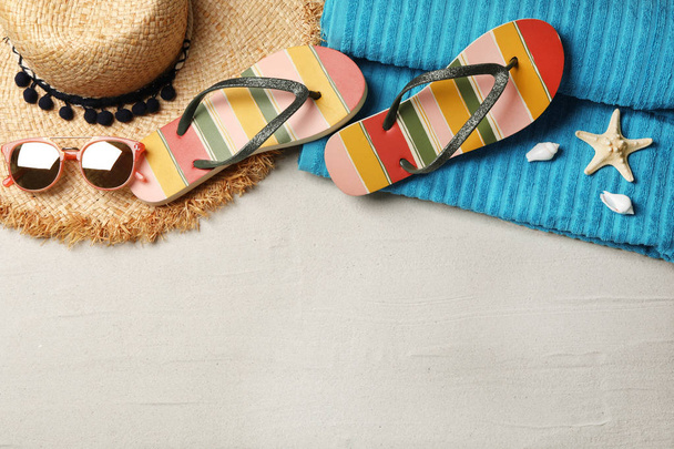 Flat lay composition with beach accessories on sand. Space for text - Photo, Image