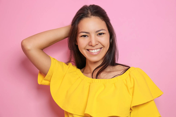 Attractive young woman posing on color background - Photo, image