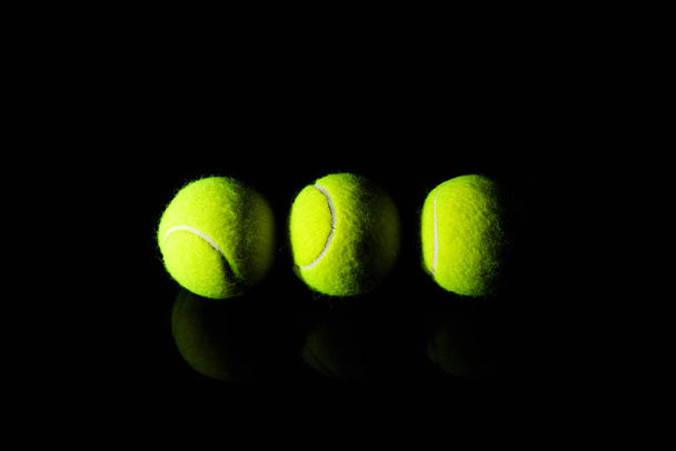 Tennis Ball isolated on black with dramatic lighting - Photo, Image