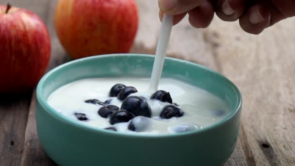 Mixing blueberry fruit in yogurt - Footage, Video