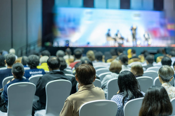 Rear view of Audience listening Speakers on the stage in the conference hall or seminar meeting, business and education about investment concept - Photo, Image