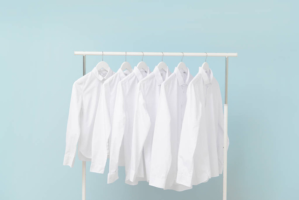 Rack with clothes after dry-cleaning on light background - Fotografie, Obrázek