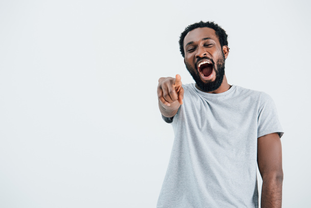 african american man laughing and pointing isolated on grey - Zdjęcie, obraz