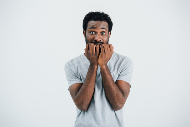 worried african american man in grey t-shirt, isolated on grey - Fotó, kép