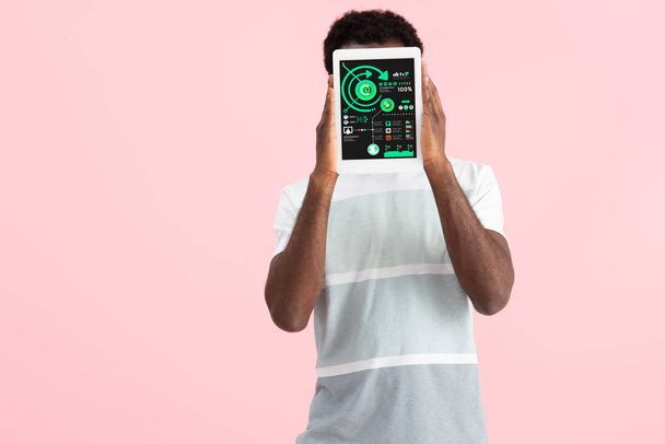 african american man showing digital tablet with infographic app, isolated on pink - Foto, afbeelding