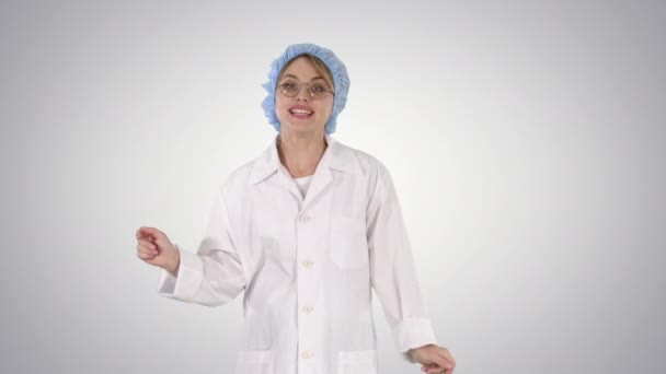 Geek young blonde doctor woman talking to camera on gradient background. - Materiał filmowy, wideo