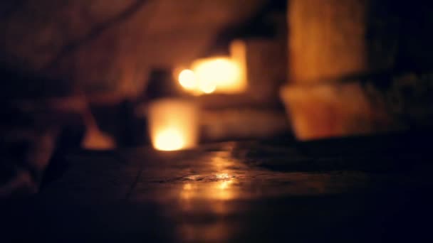 Silhouet van menselijke figuur/lichaam wandelen langs de trap verlicht door het gebruik van kaarsen in een griezelige donkere locatie. - Video