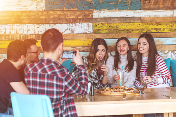 Group of happy friends having fun taking selfie at brewery bar restaurant sharing pizza and drinking limonade - Z generation friendship concept with young millenial people hanging out together - Photo, image