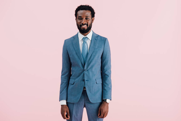 smiling african american businessman in suit, isolated on pink - Φωτογραφία, εικόνα