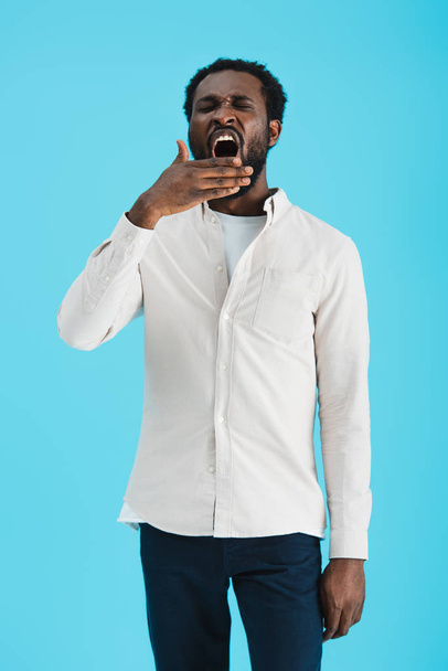tired african american man yawning isolated on blue - Photo, Image