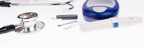 Stethoscope and blood glucose meter for measuring blood sugar test strips. Isolated - Photo, Image