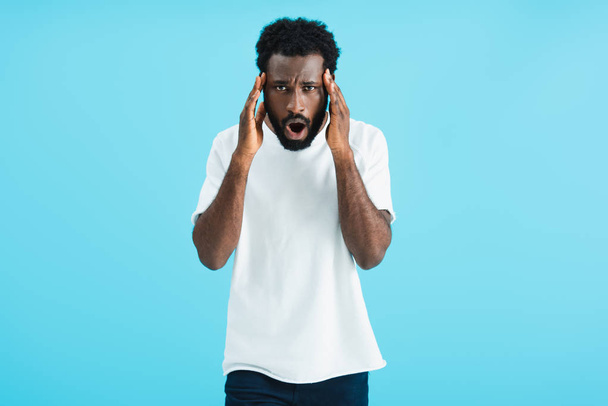 african american man in white t-shirt having headache, isolated on blue   - Foto, Bild