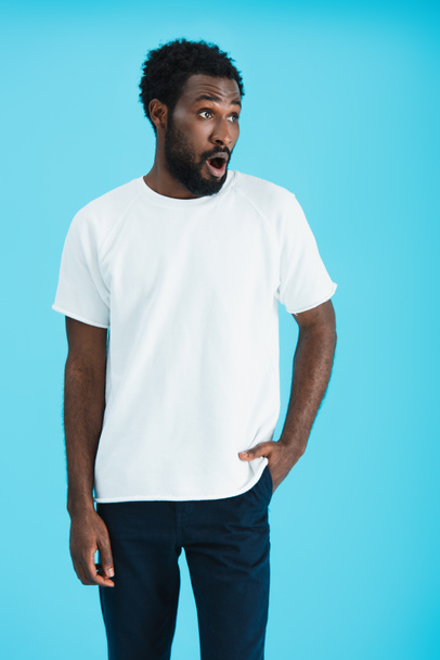 shocked african american man in white t-shirt, isolated on blue   - Foto, afbeelding