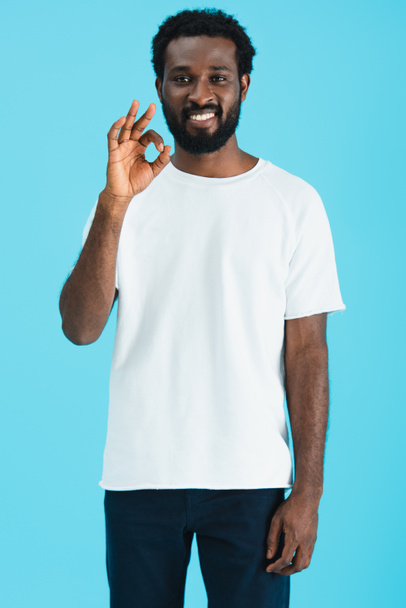 happy african american man showing ok sign isolated on blue - Фото, изображение