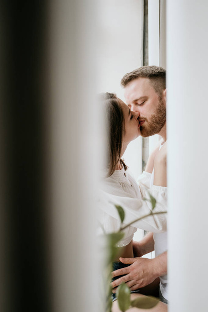 Couple in love in the bedroom. Slender brunette. Stylish interior. - Fotoğraf, Görsel