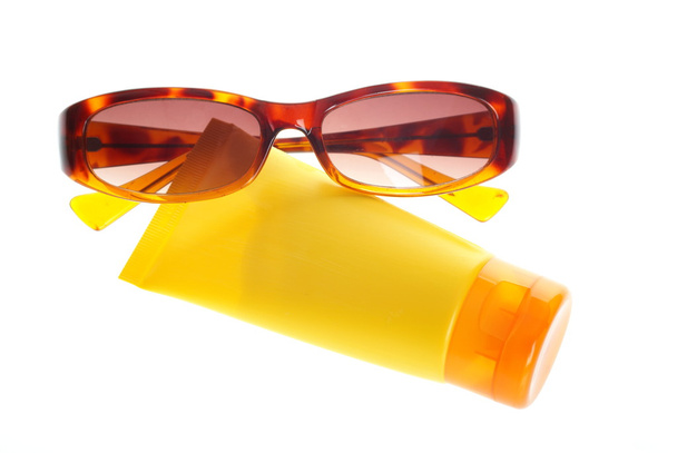 Sunglasses and sun lotion - Foto, imagen