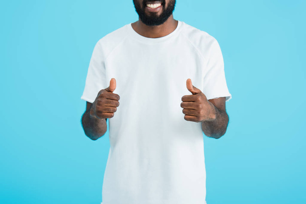 cropped view of african american man showing thumbs up isolated on blue - Fotoğraf, Görsel