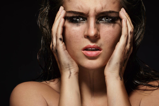 Beautiful woman with smudged makeup on her face - Fotó, kép