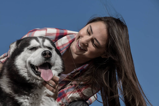 Cheerful lady scratching funny dog - Foto, imagen