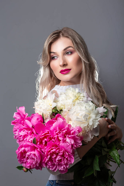beautiful girl, natural beauty, feminism. woman with a bouquet of peonies - Photo, Image