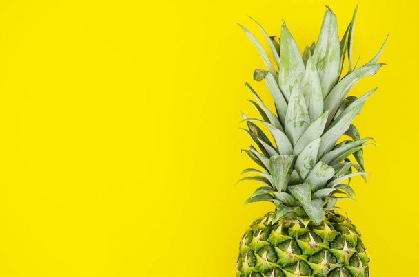 Flat lay summer fruits concept. Pineapple on yellow background. Horizontal closeup frame with copy space - Фото, зображення